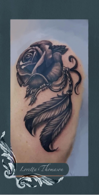 Loretta Thomason rose feather tattoo